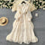 French high-end women's dress for spring 2025 with waist cinching, heavy embroidery, V-neck lantern sleeves, single breasted long skirt